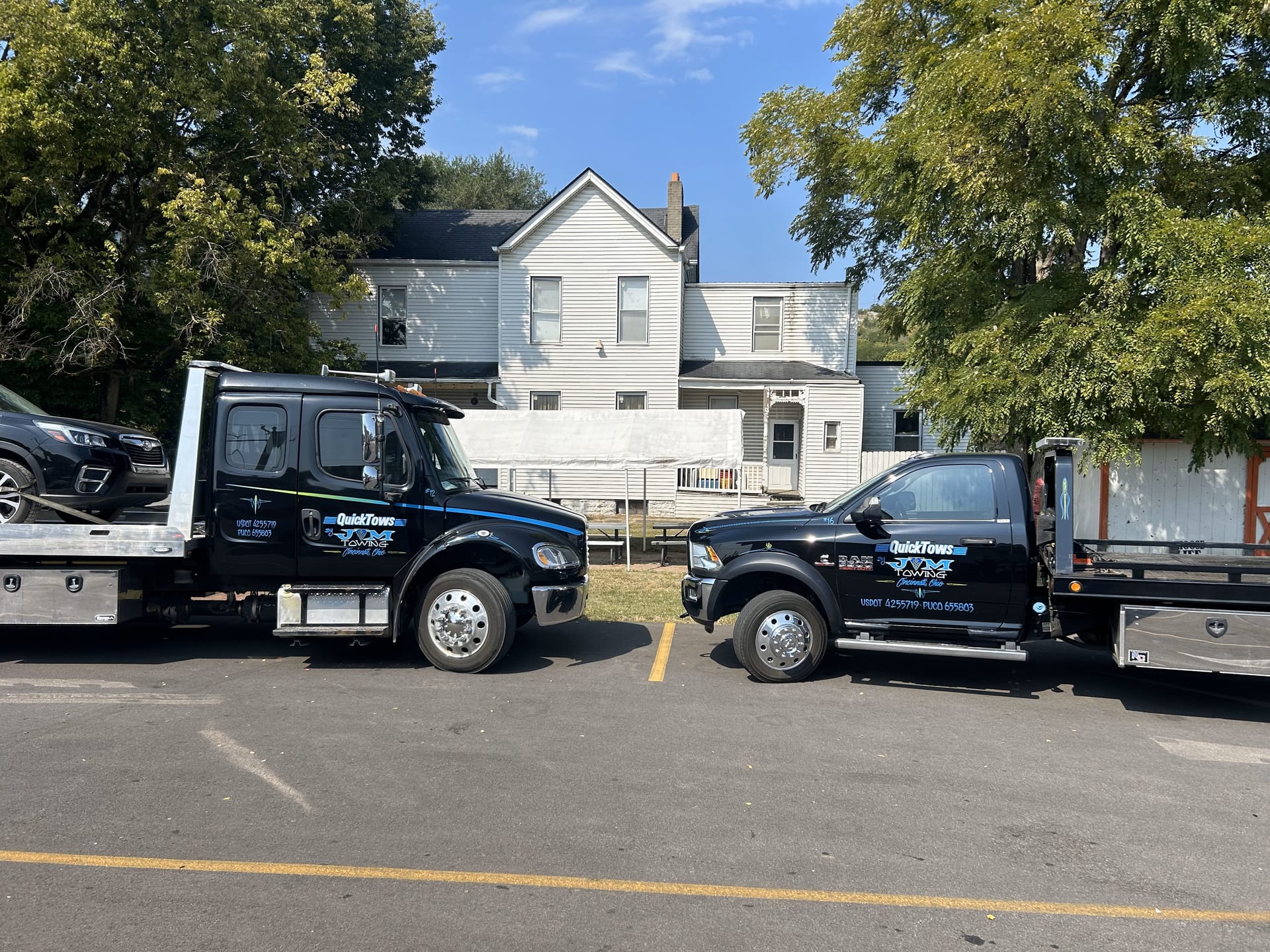 QuickTows flatbed tow truck on the road in Cincinnati